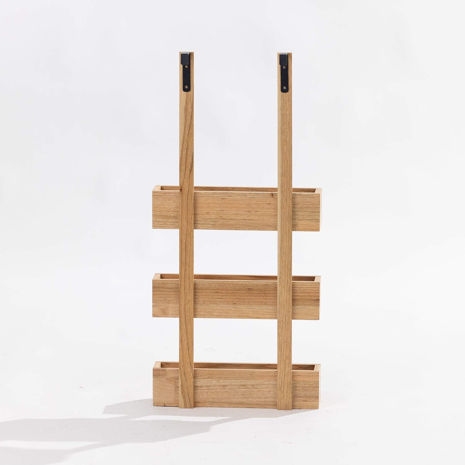 A three-tier wooden over door storage shot in a studio setting back view. 
