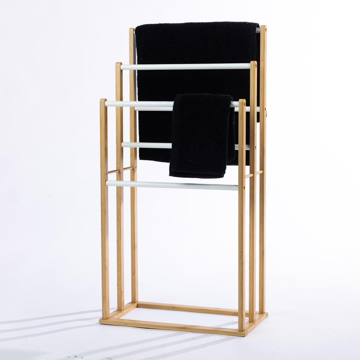 Solace Patten 6 Bar Towel Rail in Natural White, featuring a natural bamboo frame with white rails and black towels draped over the bars.