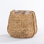 Large natural woven basket with braided handles and a clear inner liner, shown against a white background.