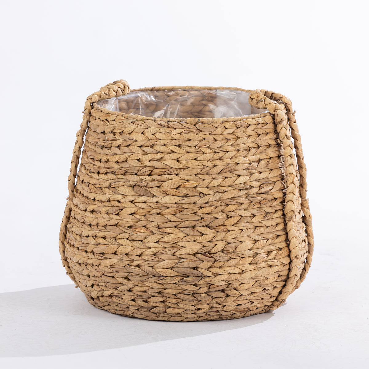 Large natural woven basket with braided handles and a clear inner liner, shown against a white background.