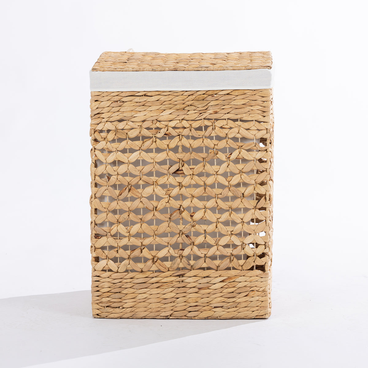 Natural woven laundry hamper with a decorative open weave design, matching lid and white fabric trim, shown closed against a white background.