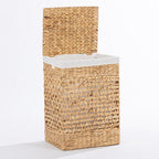 Natural woven laundry hamper with a hinged lid and white fabric lining, shown open against a white background.