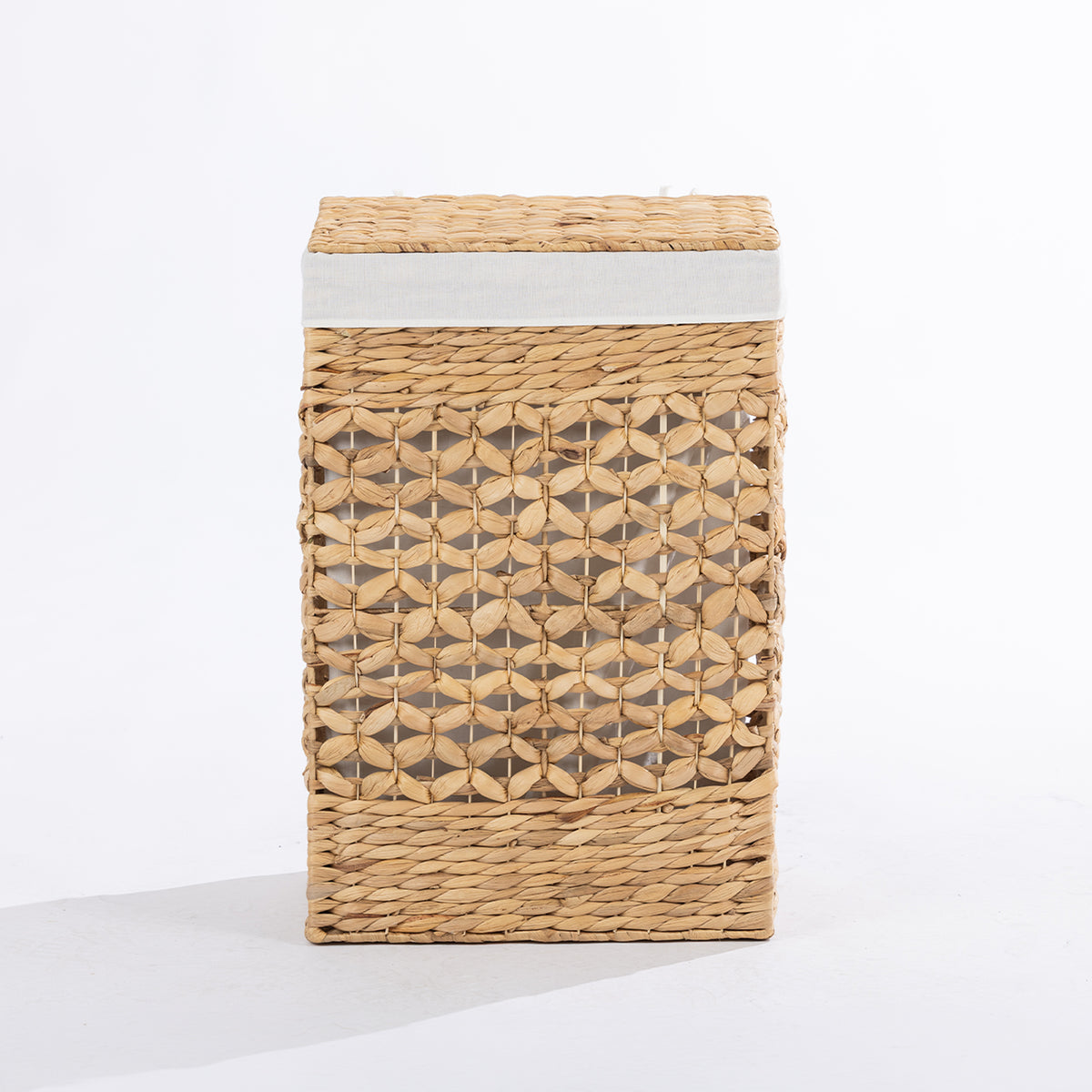 Natural woven laundry hamper with a decorative open weave design, matching lid and white fabric trim, shown closed against a white background.