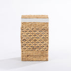 Natural woven laundry hamper with a decorative open weave design, matching lid and white fabric trim, shown closed against a white background.