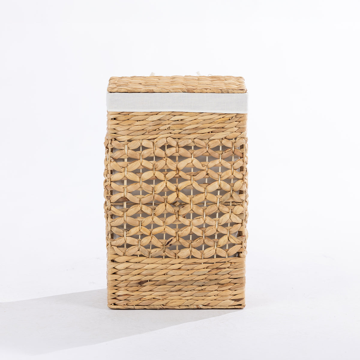 Natural woven laundry hamper with a decorative open weave design, matching lid and white fabric trim, shown closed against a white background.
