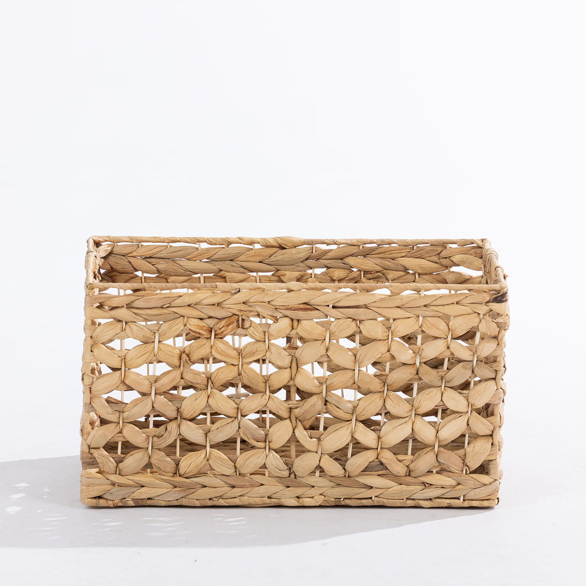 Natural woven rectangular storage basket with an open decorative weave, shown at a slight angle against a white background.