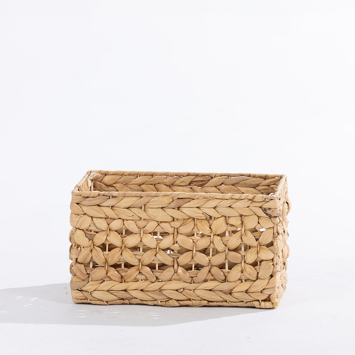 Natural woven rectangular storage basket with an open decorative weave, shown at a slight angle against a white background.