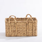 Large natural woven rectangular basket with braided handles, shown against a white background.