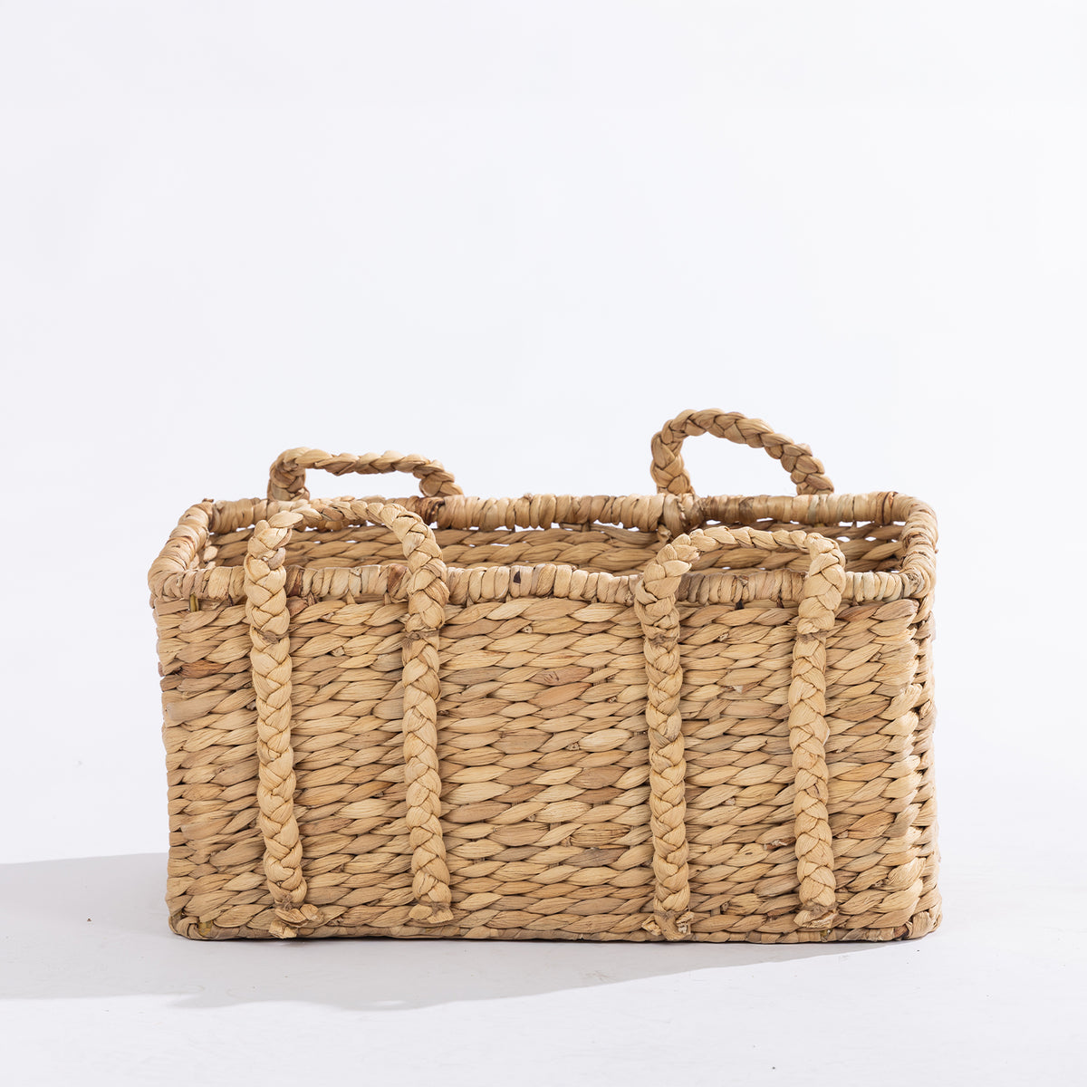 Medium natural woven rectangular basket with braided handles, shown against a white background.