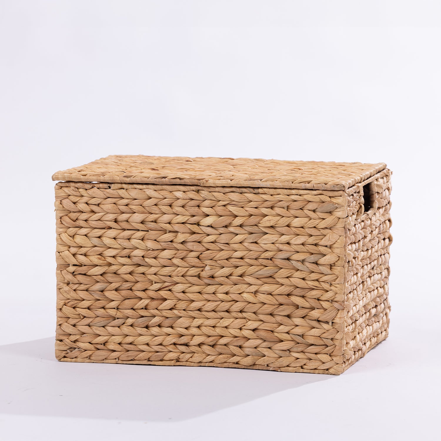 A rectangular woven storage basket with a lid, made from natural straw in a light tan color, photographed on a clean white background.