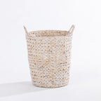A natural woven laundry basket with two loop handles, shown on a clean white background.