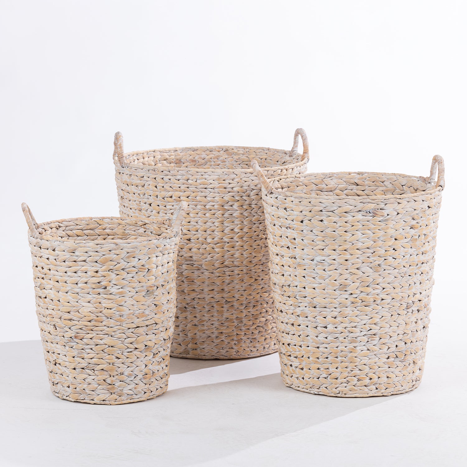 Three woven  storage baskets in nested sizes with double loop handles, shown on a clean white studio background.