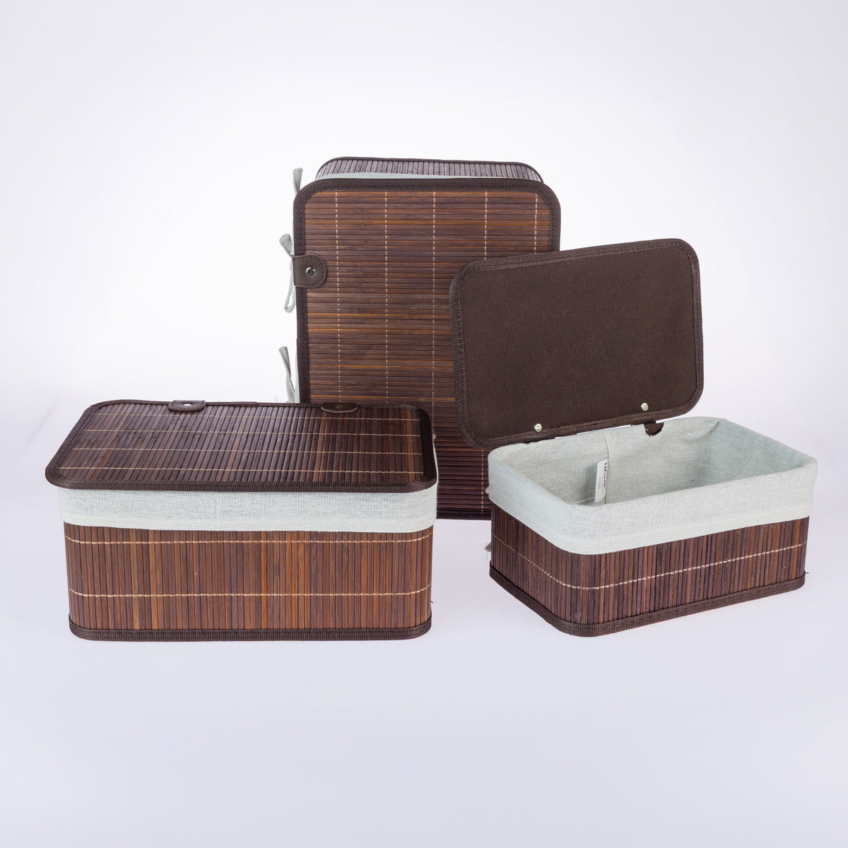 Home Co. Ashton Bamboo Storage Basket Set with Lids in Brown, featuring rectangular bamboo baskets with dark brown trim, cream fabric linings and matching lids, displayed open and closed on a white background.