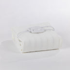 A folded electric blanket with two controllers on top. With a white background.