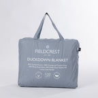 A premium feather and down blanket neatly packed in a soft carry bag, featuring a luxurious cotton cover, satin border, and plush duck down fill for lightweight warmth.