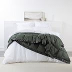 A luxuriously soft feather and down blanket in a rich forest green tone, finished with elegant satin trim for a warm and sophisticated bedroom look.