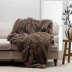 A richly textured taupe faux-fur throw draped over a neutral sofa brings warmth, softness, and understated luxury to the living space.