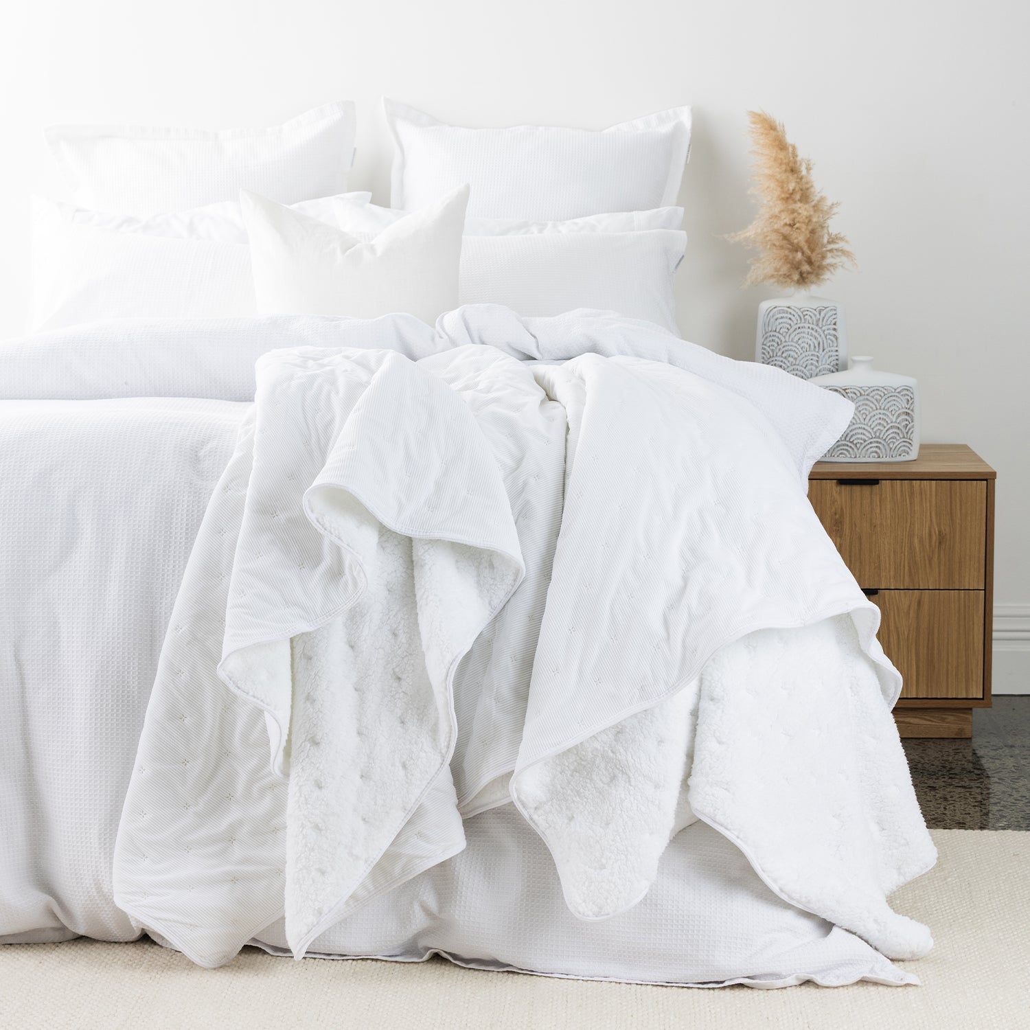 White blanket styled on bed
