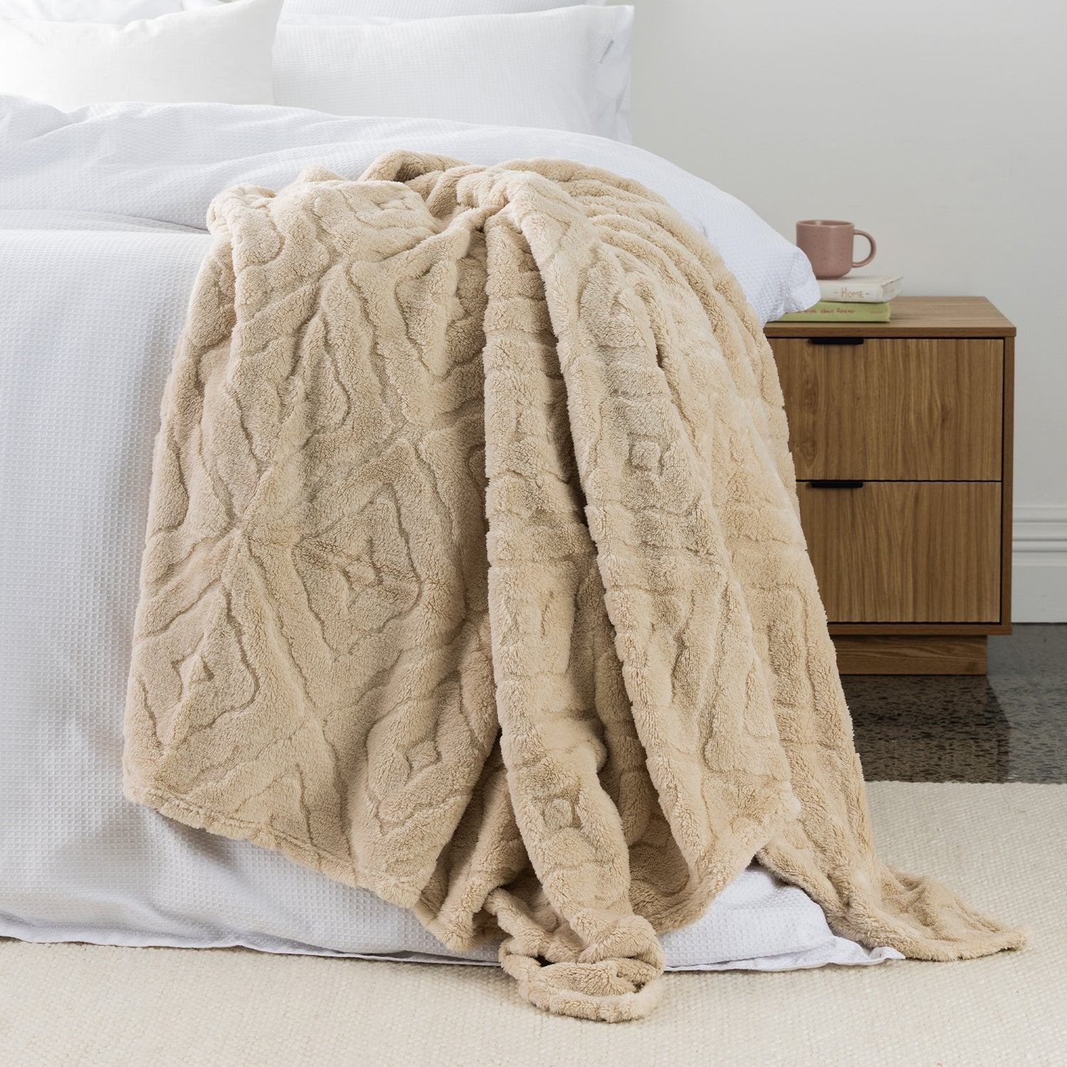 Natural Colour Embossed fleece blanket styled on the end of bed