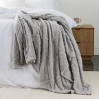 Silver grey Colour Embossed fleece blanket styled on the end of bed