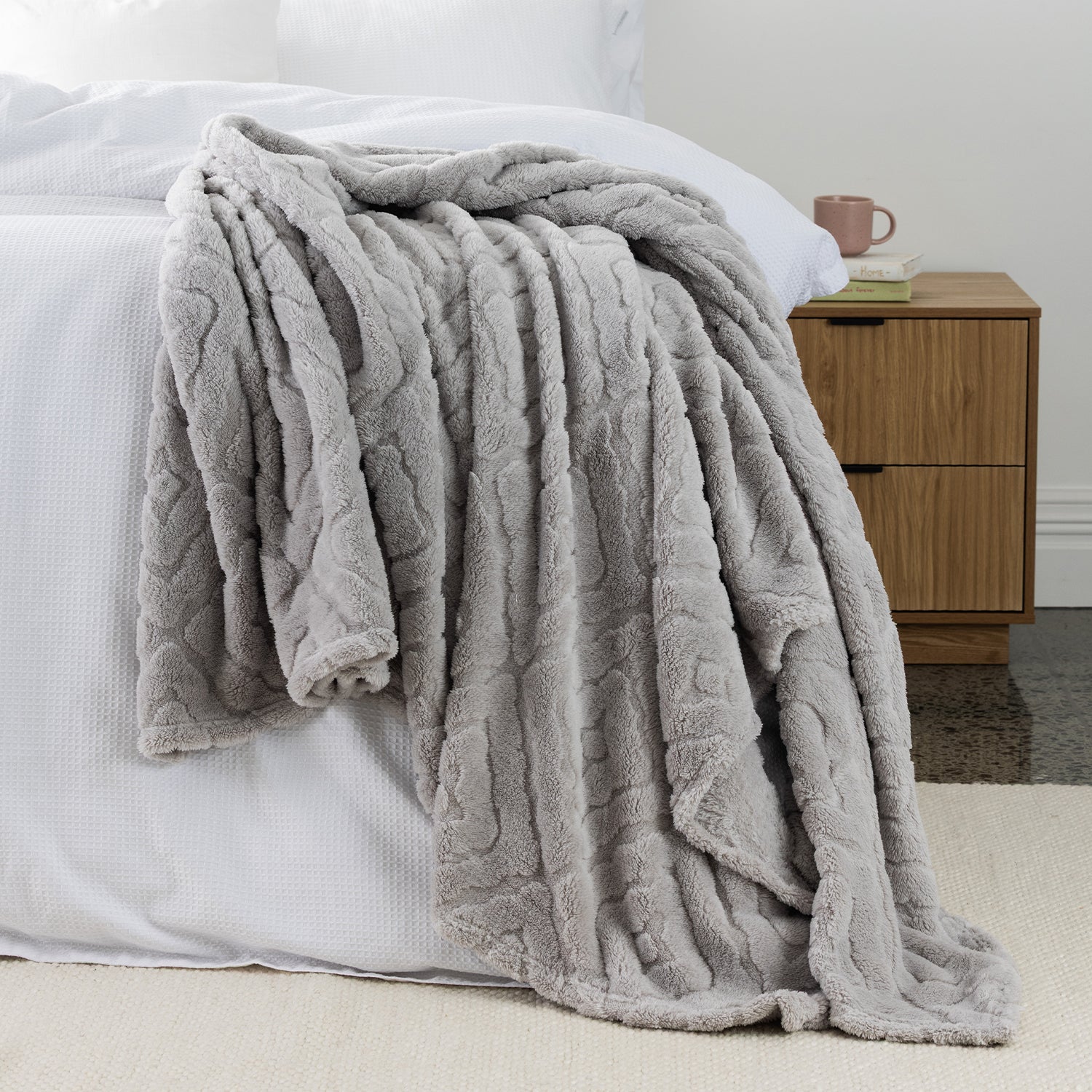 Silver grey Colour Embossed fleece blanket styled on the end of bed