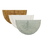 Half-moon bathmat range featuring soft textured finishes with curved contrast stripe detailing in mustard, mint, and cream colourways on a clean white background.