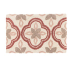 Bathmat featuring a floral tile-inspired tufted design in warm earthy tones on a clean white background.