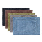 Bathmat range featuring plush textured designs in charcoal, chocolate, denim, khaki, and silver colourways on a clean white background.