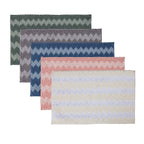 Bathmat range featuring soft bobble textures with toggle-inspired zigzag patterns in green, grey, blue, pink, and cream colourways on a clean white background.