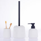 White ribbed bathroom accessory set including a tumbler with bamboo toothbrushes, toilet brush holder, and soap dispenser with black pump, displayed on a white background.