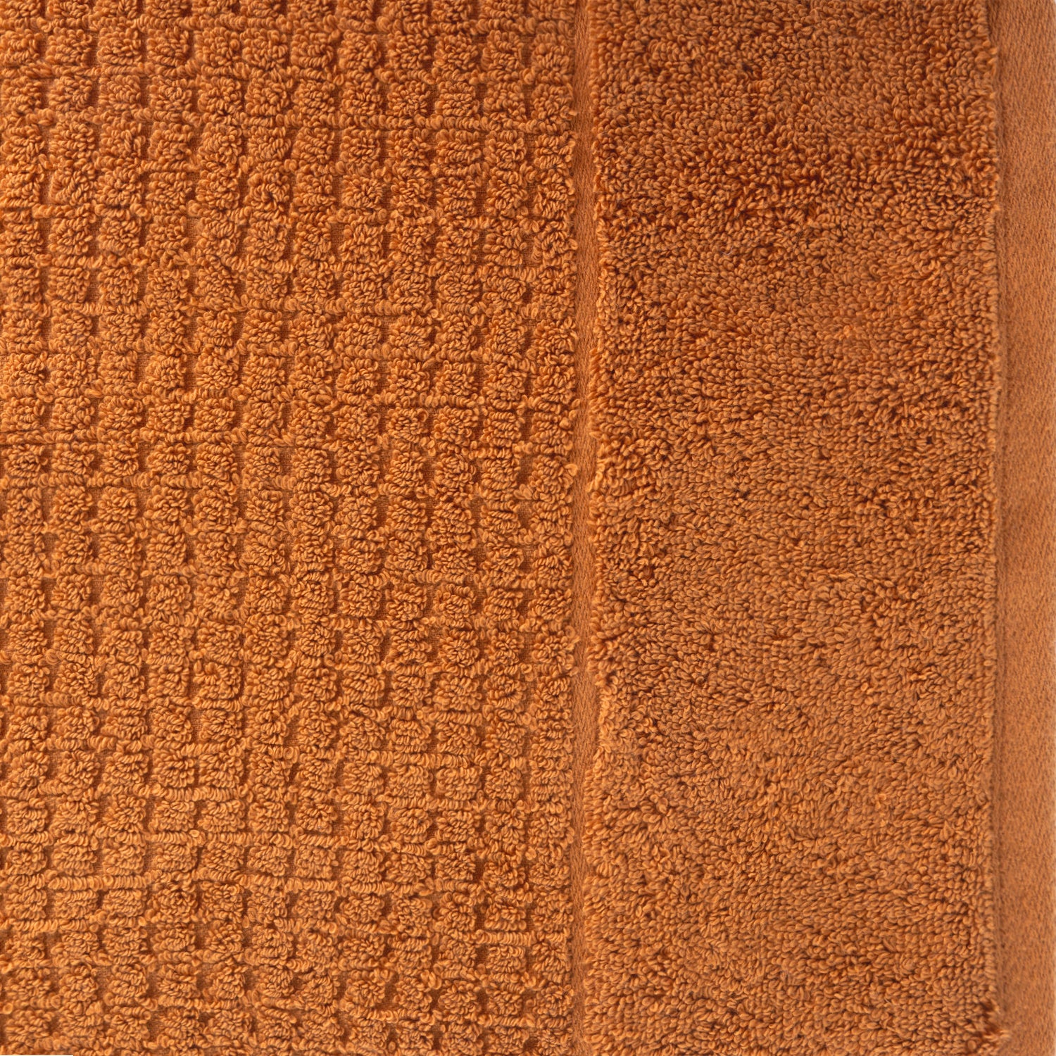 Close-up of caramel Fieldcrest Marney textured hand towel showing the raised woven pattern and soft cotton pile.