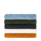 Stack of Fieldcrest Marney textured towels in blue, green, charcoal, ivory, and caramel on a white background.
