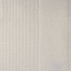 Close-up of ivory Fieldcrest Marney textured hand towel showing the raised woven pattern and soft cotton pile.