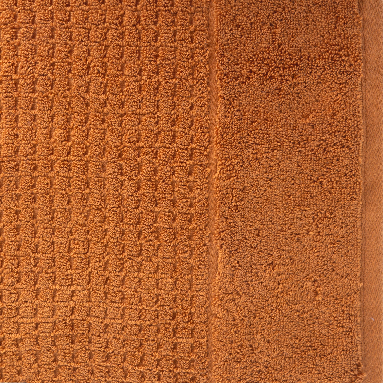 Close-up of caramel Fieldcrest Marney textured hand towel showing the raised woven pattern and soft cotton pile.