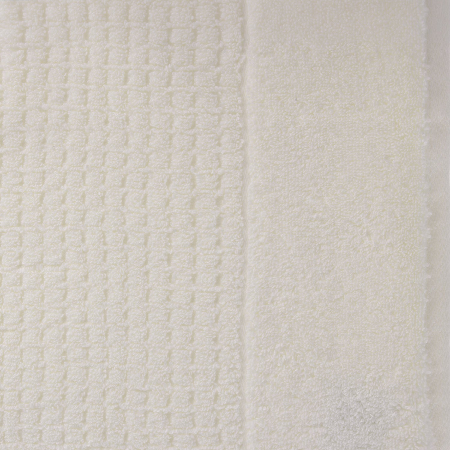 Close-up of ivory Fieldcrest Marney textured hand towel showing the raised woven pattern and soft cotton pile.