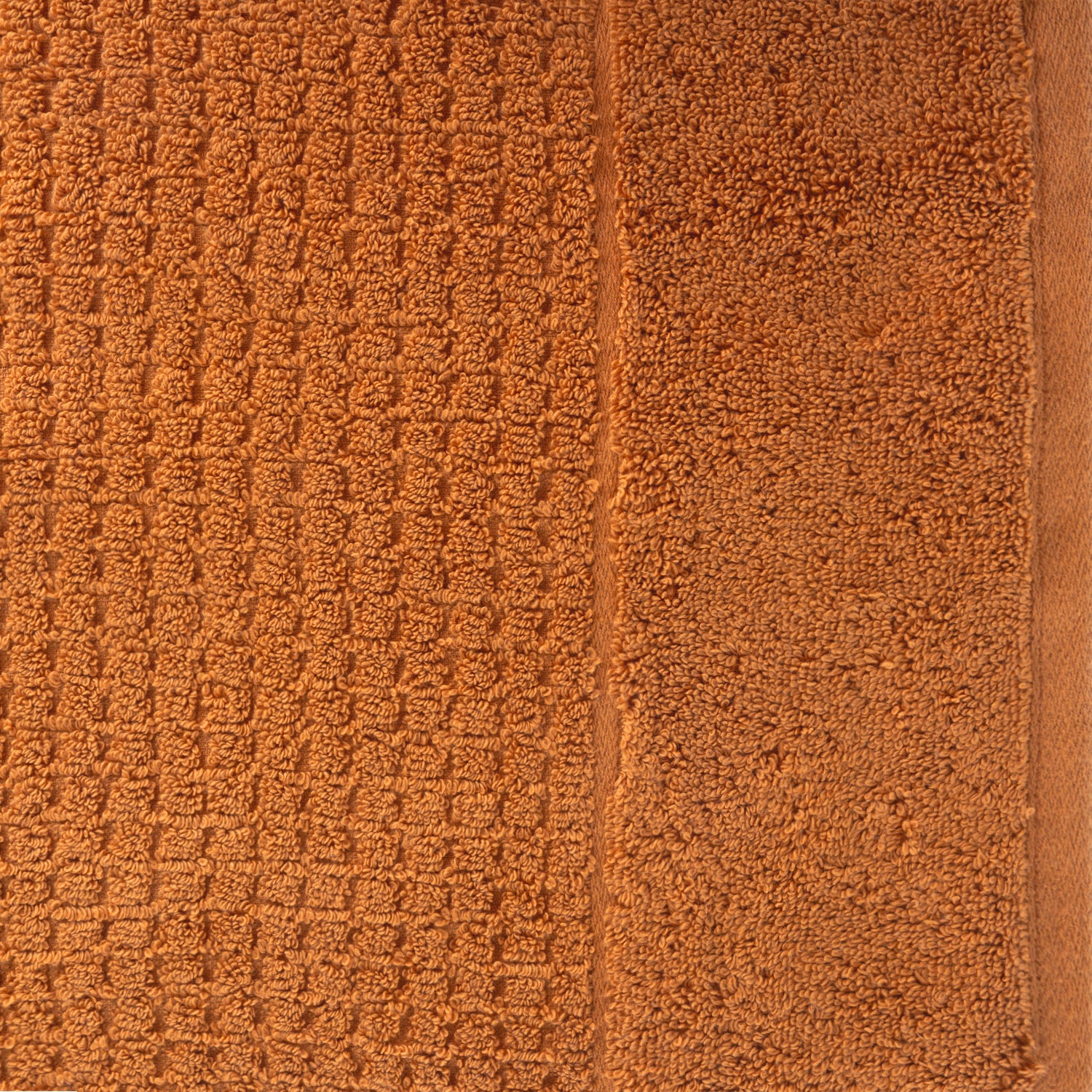 Close-up of caramel Fieldcrest Marney textured hand towel showing the raised woven pattern and soft cotton pile.
