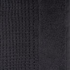 Close-up of charcoal Fieldcrest Marney textured hand towel showing the raised woven pattern and soft cotton pile.
