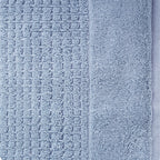 Close-up of denim Fieldcrest Marney textured face cloth showing the raised woven pattern and soft cotton pile.