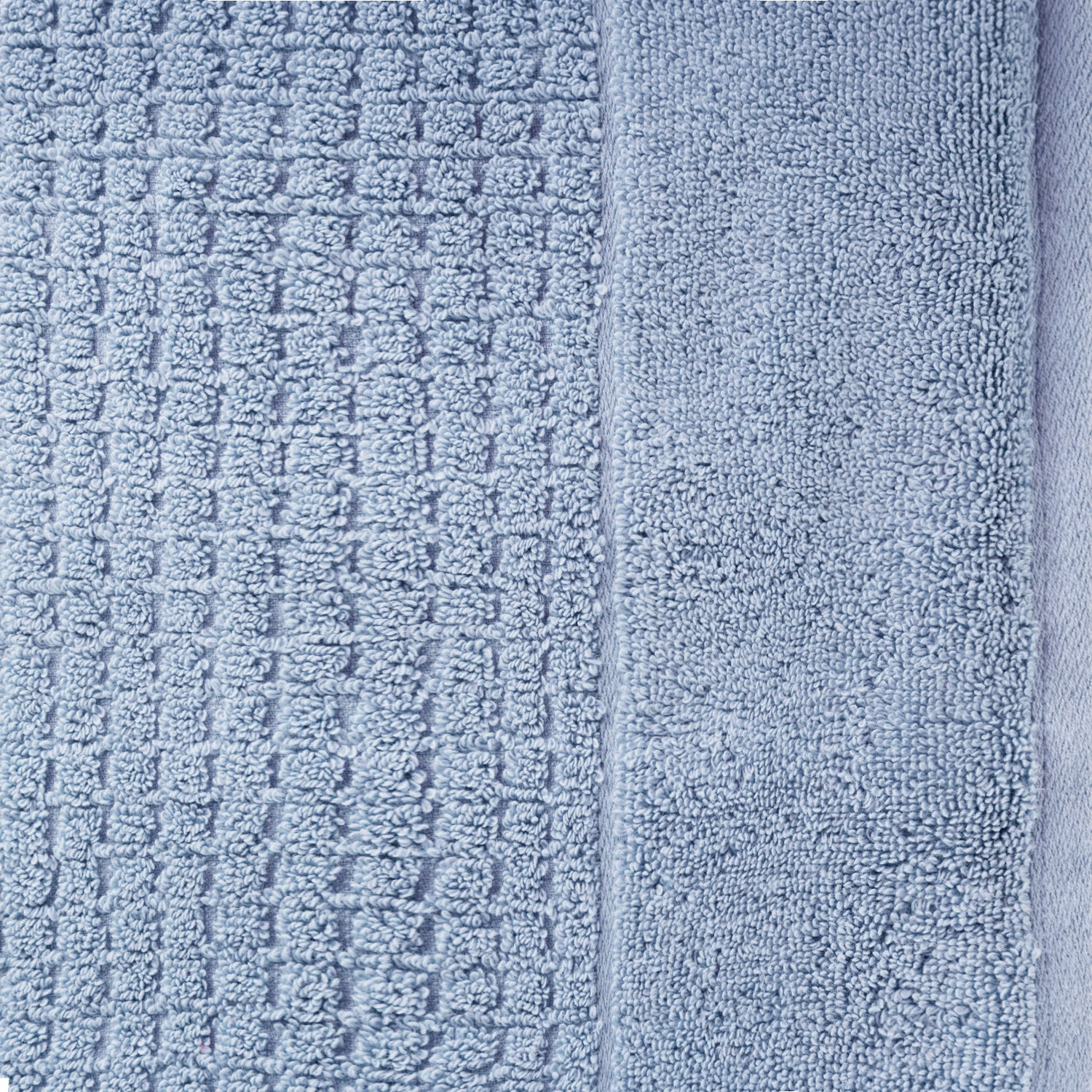 Close-up of denim Fieldcrest Marney textured face cloth showing the raised woven pattern and soft cotton pile.