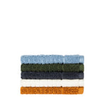Side view of folded Fieldcrest Marney textured hand towels stacked in blue, green, charcoal, ivory, and caramel.