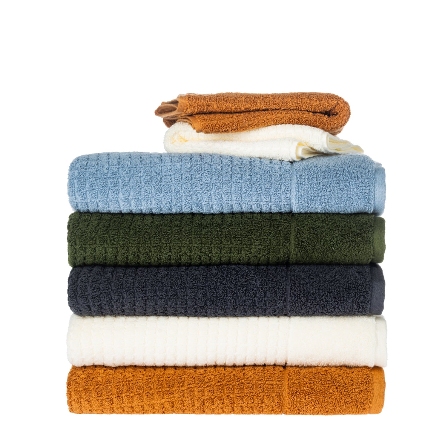Stack of Fieldcrest Marney textured towels with caramel and ivory face cloths on top.
