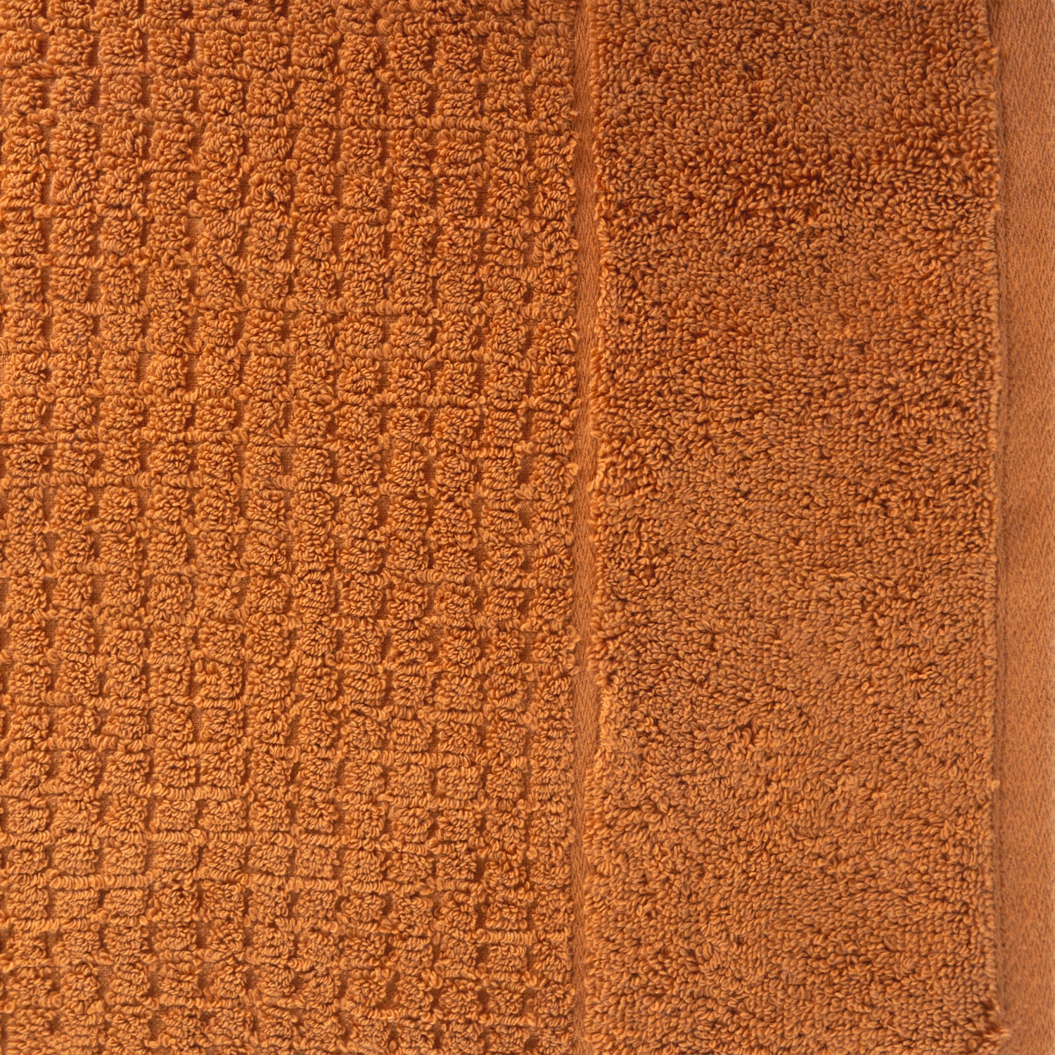 Close-up of caramel Fieldcrest Marney textured hand towel showing the raised woven pattern and soft cotton pile.