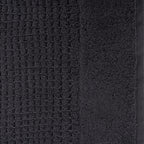 Close-up of charcoal Fieldcrest Marney textured hand towel showing the raised woven pattern and soft cotton pile.
