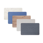 Bathmat range featuring modern geometric designs in marble, blue, wood-look, beige, and charcoal colourways on a clean white background.