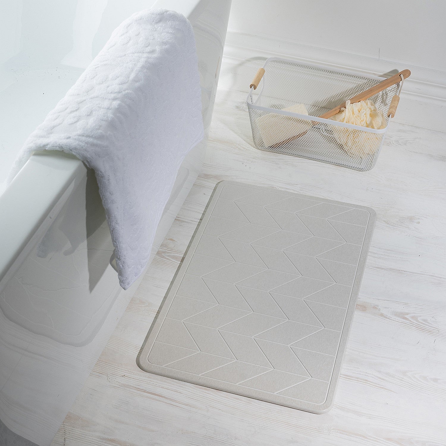 Stone look quick dry Stone bathmat featuring a modern geometric pattern, styled beside a bathtub in a bright contemporary bathroom setting.