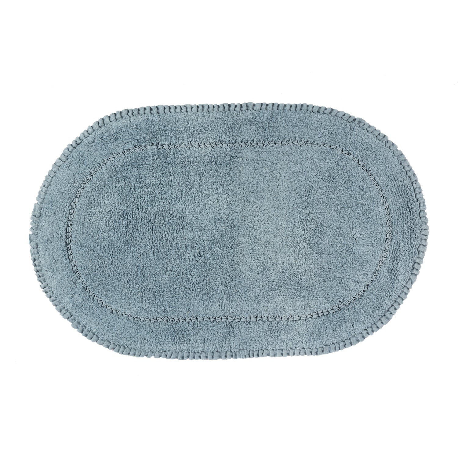 Denim blue plush oval bath mat with a soft textured pile and decorative braided border.