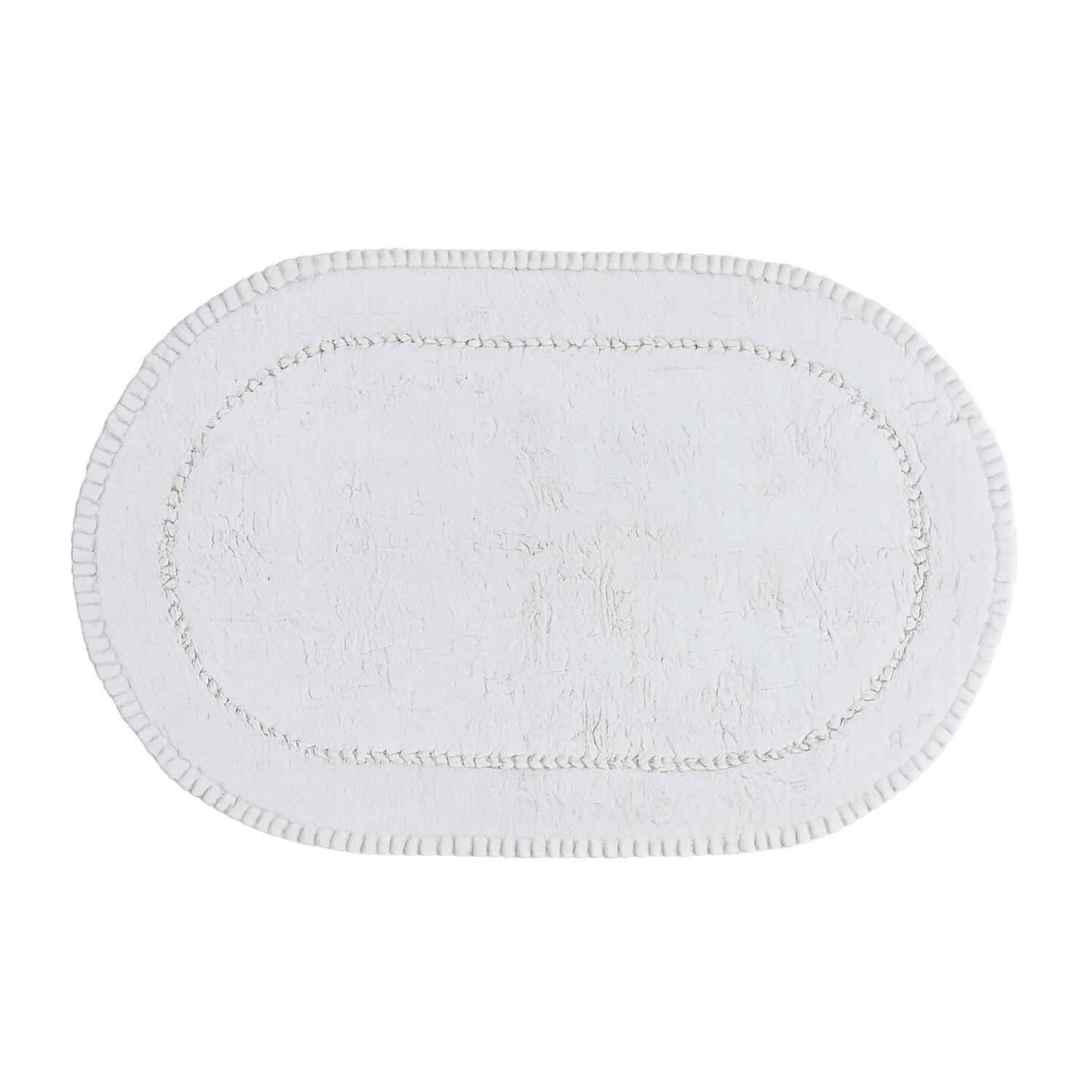 White plush oval bath mat with a soft textured pile and decorative braided border.