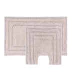 Taupe two-piece bath mat and contour mat set with a soft textured pile and bordered design.