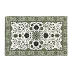 Design Republique Venica Chenille Bathmat in Green, featuring an intricate floral design in green, black and white with a decorative patterned border.