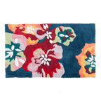 Teal bathmat featuring a bold multicoloured floral design in red, pink, orange, green and white.